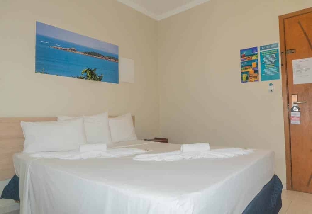 Vista do quarto do UPG Hotel com cama ampla.